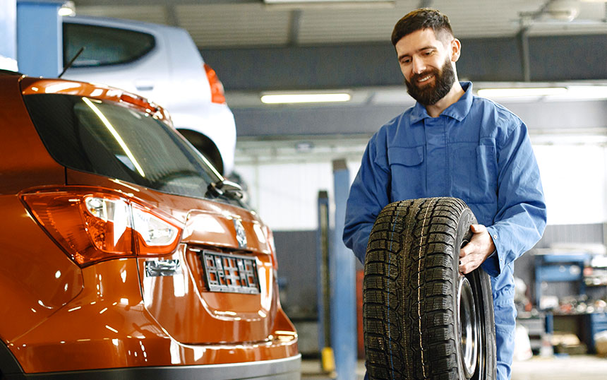 Mechanic Carrying a Wheel Mechanic Carrying a Wheel